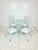 Wrought iron nautilus shell dining set. Four bistro chairs with round table base with glass top. Newly refinished in a...