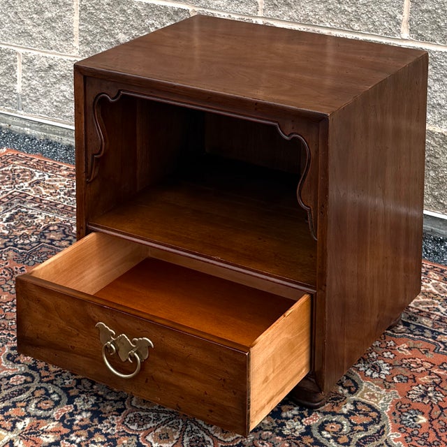 A vintage Henredon Fine Furniture Asian Inspired Chinoiserie Walnut nightstand having an open cabinet with shaped apron...