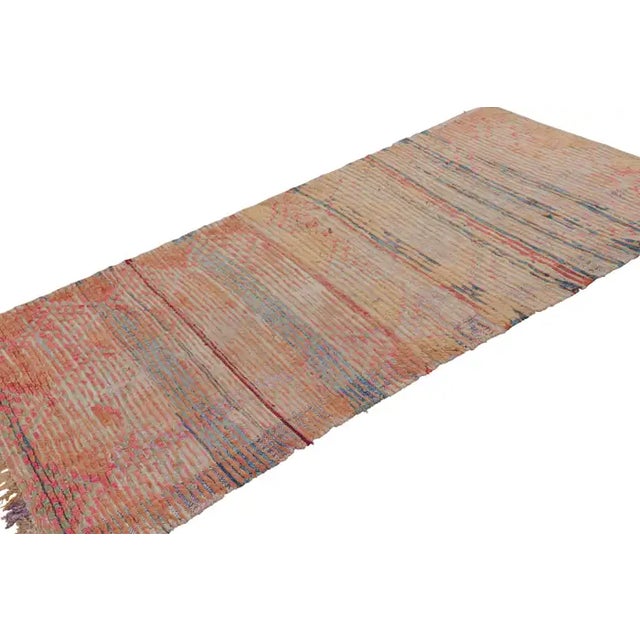 Hand-knotted in wool and originating from Morocco circa 1950-1960, this 3x8 vintage Moroccan rug is an extremely rare...