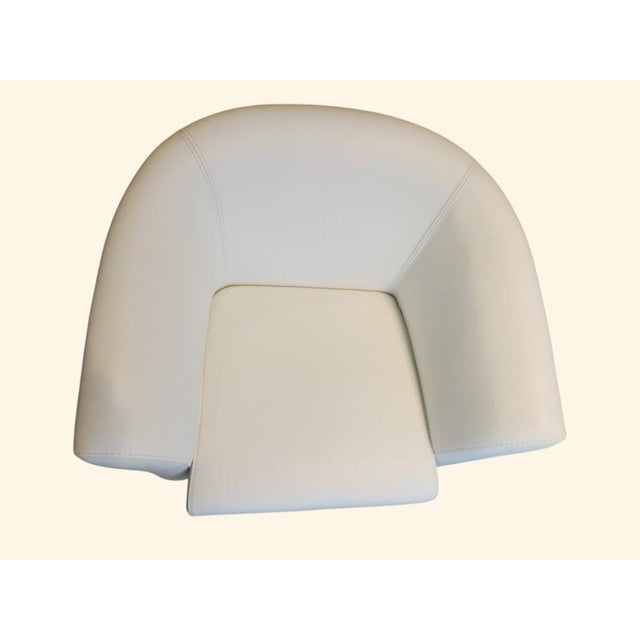 This exclusive designer armchair upholstered in natural cow leather has a contemporary and sophisticated aesthetic with a...