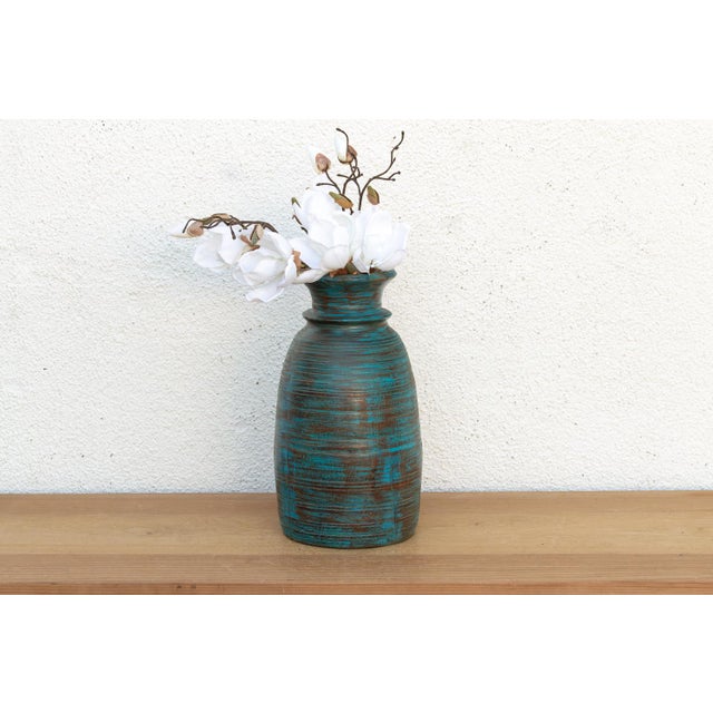 This painted wooden vase is a vibrant study in texture and color. This vintage hand-turned wooden vase features a tall,...