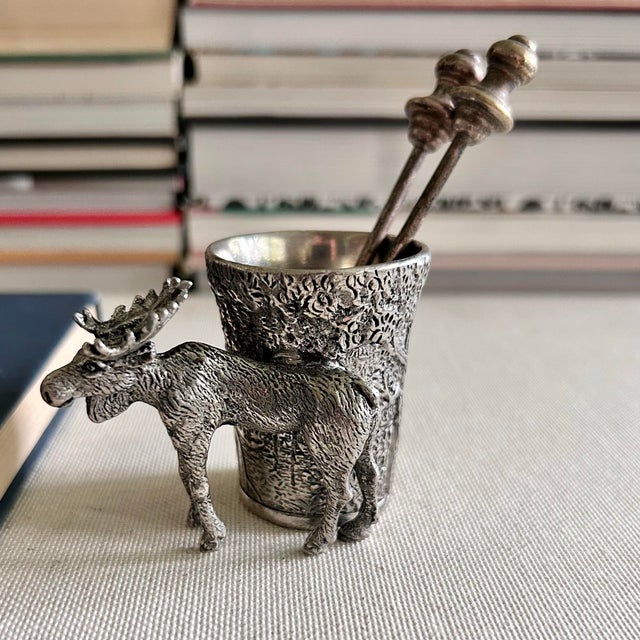 A highly detailed vintage German pewter match or toothpick holder featuring a dimensional bull moose standing beside a...