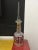 Vintage decanter in clear cranberry and gold accent and tall hand cut stopper.