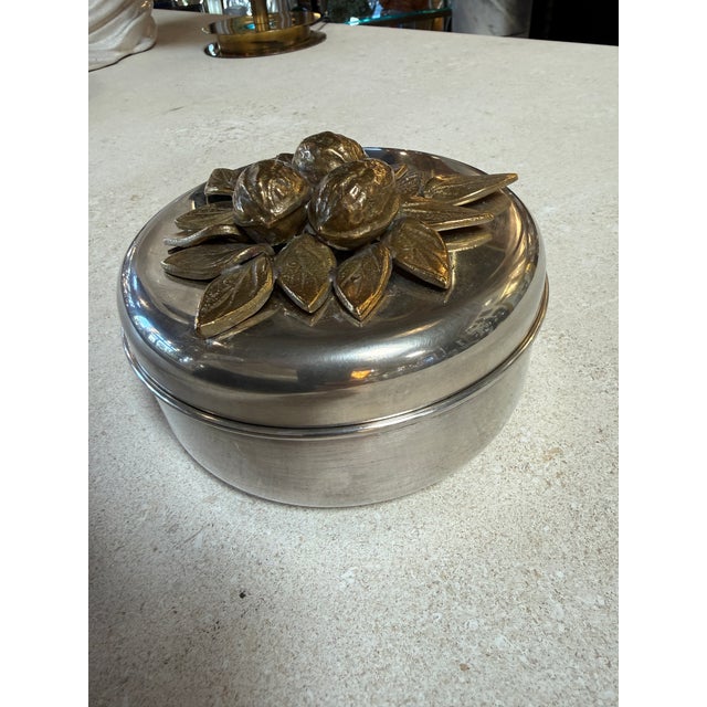Eye-catching vintage lidded box featuring a sculptural brass lemon and leaf motif set atop a sleek chrome base. The...