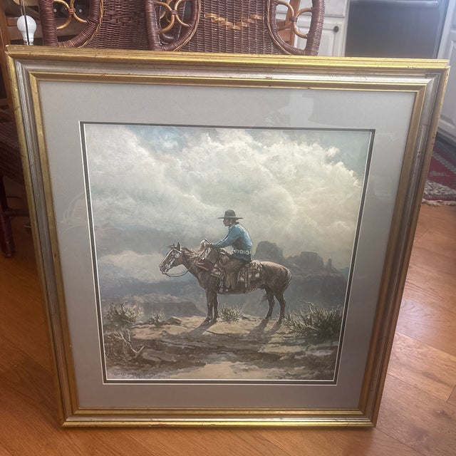 This framed artwork is a print of "The Navajo" by artist Olaf Wieghorst 1899-1988. The print is numbered 751/1500. The...