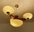 Large Art Deco pendant light featuring a wood structure with brass and trim, large central glass shade mounted on a brass...