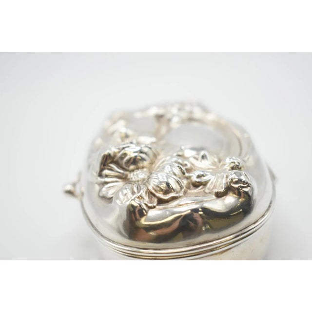 This is a stunning Art Nouveau Sterling Silver box. It has a 3D design of a woman and flowers. Markings: Sterling