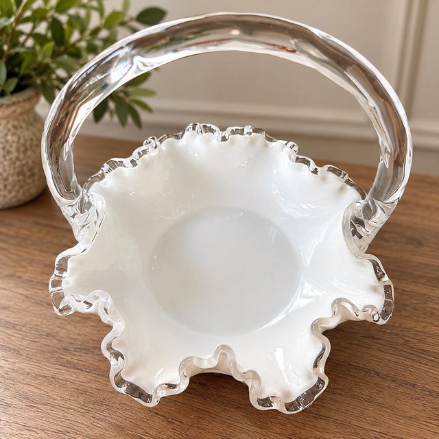 Absolutely stunning vintage Fenton art glass basket featuring an elegant white milk glass body, beautifully sculpted...