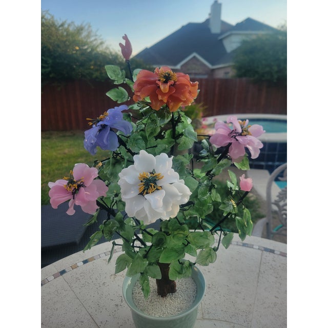 A vibrant vintage artificial floral arrangement featuring multicolored glass blossoms—orange, purple, white, pink, and...