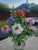 A vibrant vintage artificial floral arrangement featuring multicolored glass blossoms—orange, purple, white, pink, and...