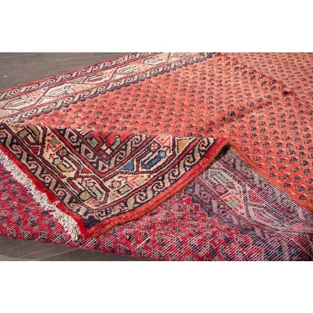 Beautiful Vintage Hamadan Handmade Wool Runner with a red field. This runner has multi-color accents in an allover multi-...