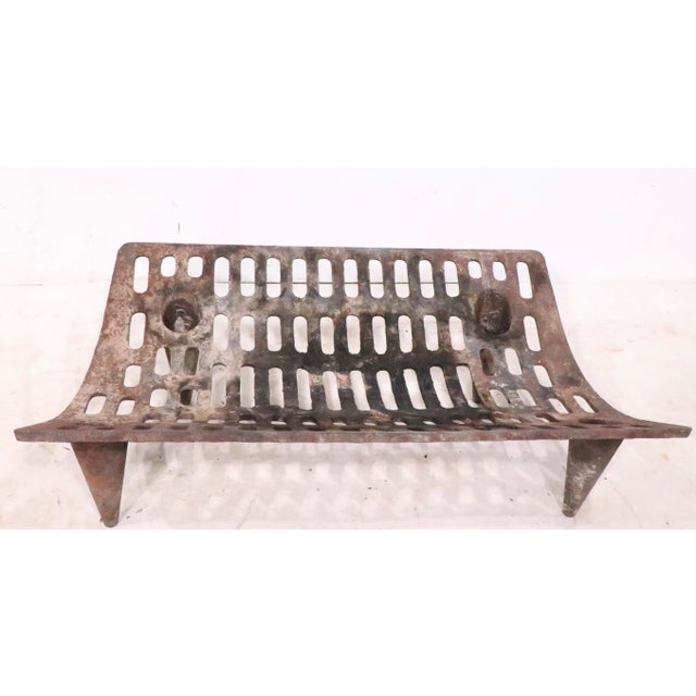 Unusual mid century fireplace insert grate, with a curved body, on tapered cone form legs. The cast iron grate in ois...
