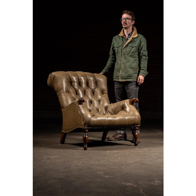 Classic leather Sleepy Hollow chair characterized by its deep, low-slung seat, pronounced recline, and enveloping, high...