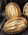 ​An extensive, highly curated collection of 17 vintage kitchen molds, featuring a stunning array of metallic copper-toned...