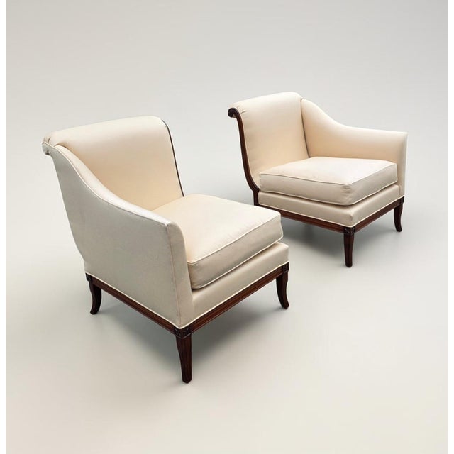 A sophisticated pair of Federal Revival mahogany armchairs in the Neoclassical tradition, dating to the mid-20th century....
