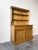 This antique English pine hutch kitchen dresser features a top shelf or plate rack with traditional cup hooks, perfect for...