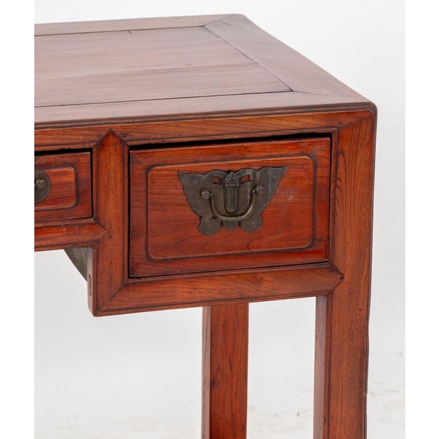 Chinese Elm Writing Desk, 19th century, having four drawers with brass butterfly form drawer pulls and lattice paneled...