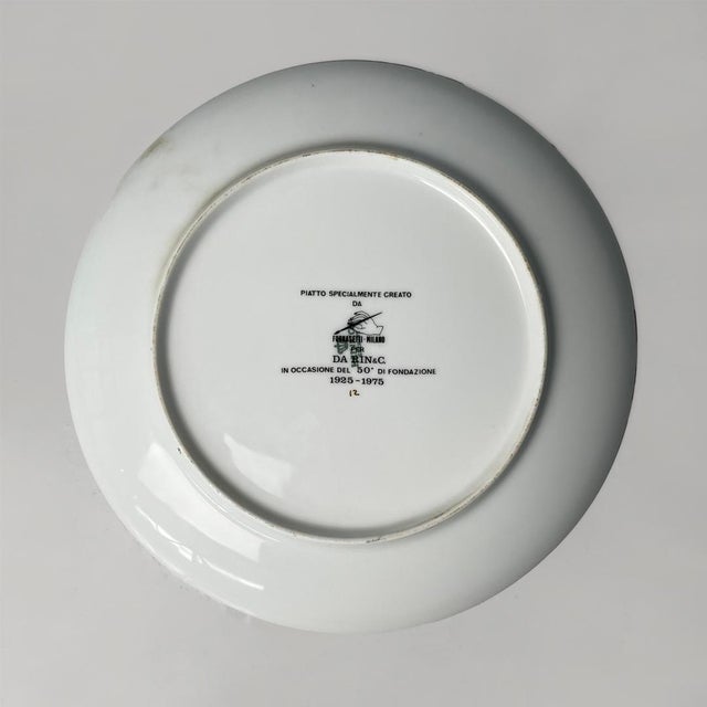 Italian decorative porcelain plate by Fornasetti, 1975 Commemorative plate in glazed white porcelain. Black lithographic...