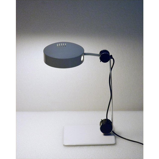 Martinelli Luce table lamp produced in the 1970s. In chromed and painted metal, adjustable stem and diffuser. Original...