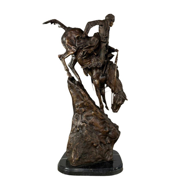 Bring the rugged spirit of the American frontier into your space with this striking patinated bronze sculpture, "The...