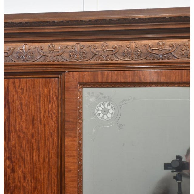 This exceptional late-19th to early-20th-century four-door wardrobe showcases superb craftsmanship, rich materials, and...