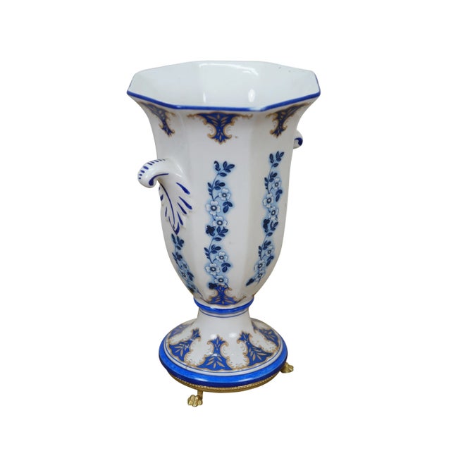 Pair of mid 20th century porcelain footed mantel vases featuring and octagonal shape decorated with vines of blue and...