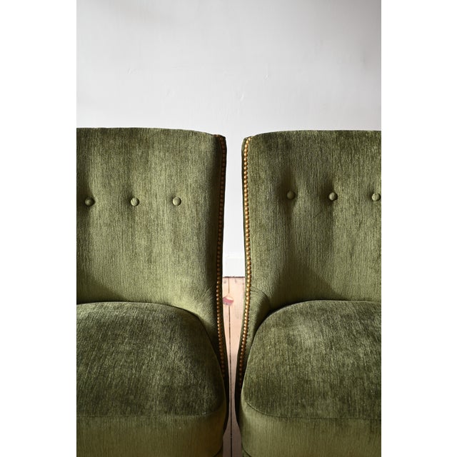 Charming, plush, art deco period slipper chairs. New emerald green upholstery is secured with a pretty brass nailhead trim...