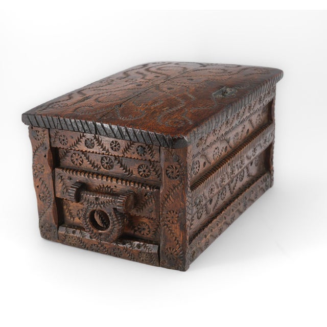 A lovely 19th century oak lidded-top table chest with hand carved leaf scrolls and roundel carvings, having swivel...