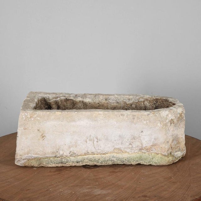 Enhance your space with this charming elongated stone basin, carved from a single block of stone, featuring two holes to...