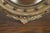 An English silver leaf convex girandole bullseye mirror from the early 20th century, with carved eagle motif and volutes....