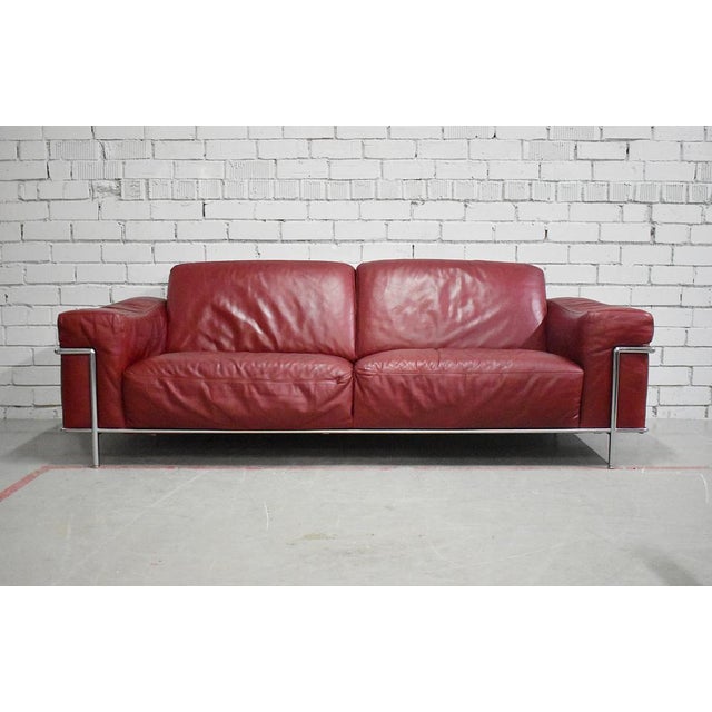 Very comfortable leather sofa with outside tubular metal frame. Manufactured by Natuzzi, Italy. This piece has an...