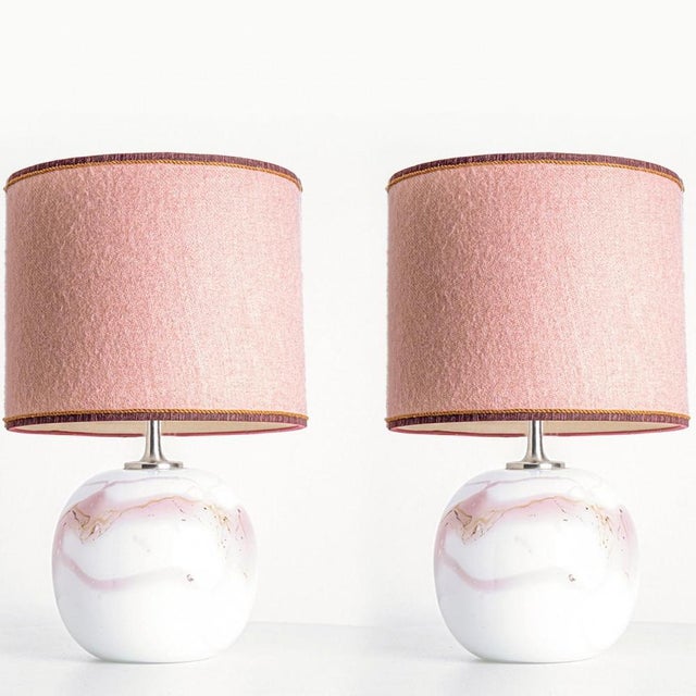 Pair of heavy quality glass table lamps by Holmegaard, 1970s. The design features a white and pink design on traditional...
