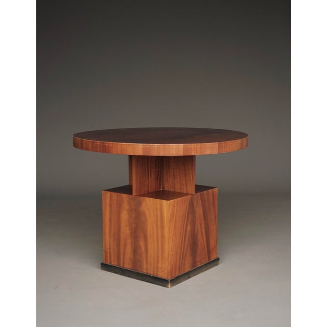A very stylish Art Deco coffee table or side table from the 1930s. It has a circular top on a cubist, geometric base...