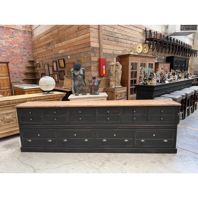 This large, vintage cabinet from the 1930s has been fully restored. It features a black-patinated body and a raw wood top....