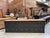 This large, vintage cabinet from the 1930s has been fully restored. It features a black-patinated body and a raw wood top....