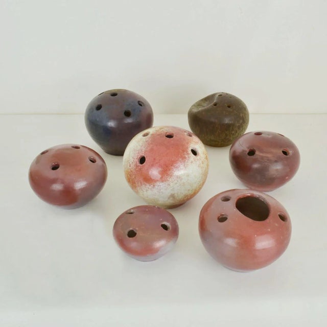 A group of seven organic ball shaped Studio Pottery vases in natural colours, were produced in the 1960s. The individual...