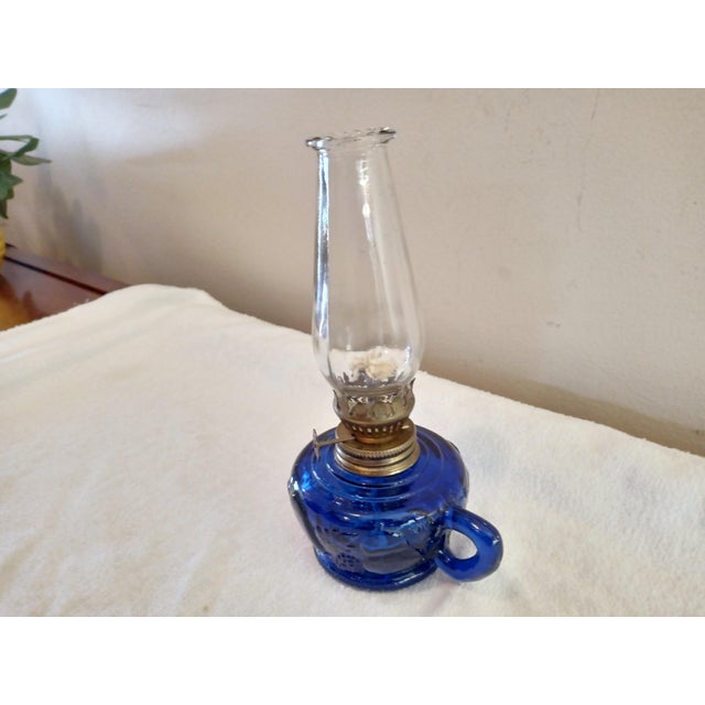 Vintage Miniature Finger Oil Lamp Cobalt Blue Glass Base Embossed Fruit Shapes. Lamp is in excellent like new condition,...