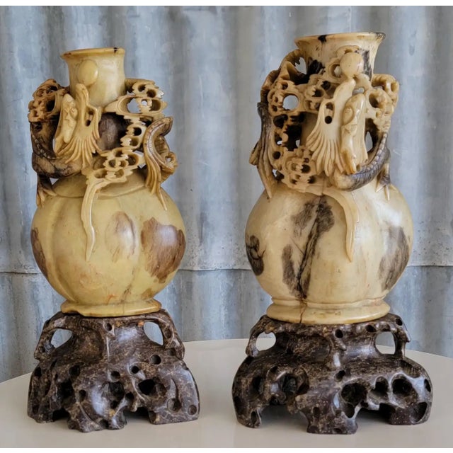 A vintage pair of hand carved soapstone vases or sculptures with a dragon motif. Each measures: 10 inches high. 5.25...