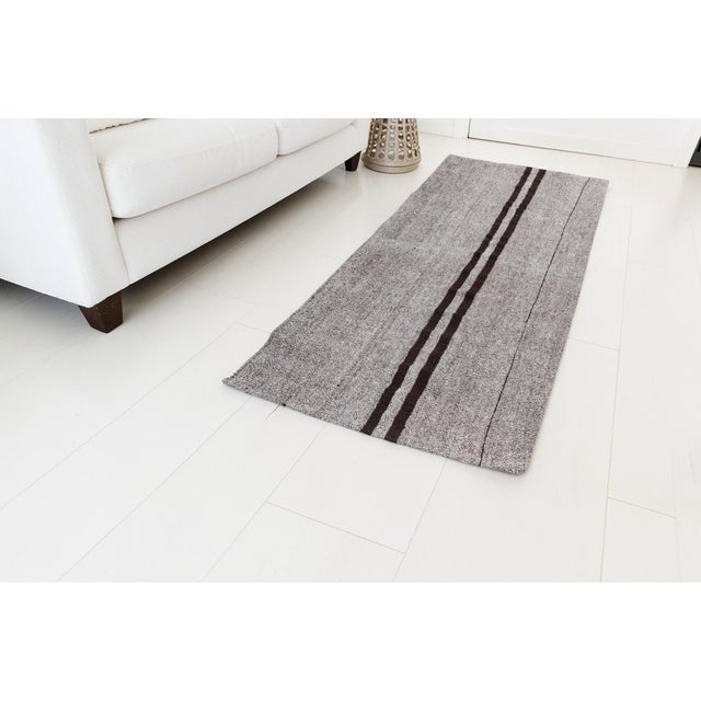 This is a vintage Turkish Oushak rug from the Mid 20th Century. The piece was hand-knotted.