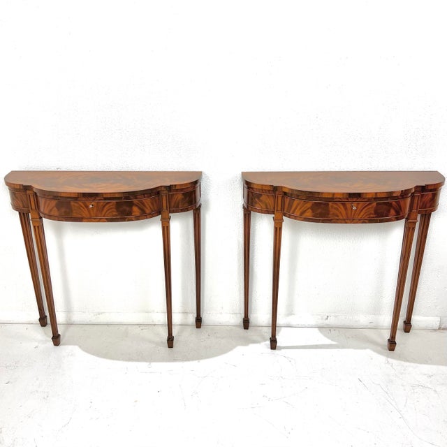 A refined pair of custom demi-lune console tables crafted in Dallas by J. Manheim in the 1990s, drawing from classic...