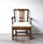 An early 18th-century, c. 1710-1720, Georgian armchair with a Chippendale splatted back, curved armrests, and turned...