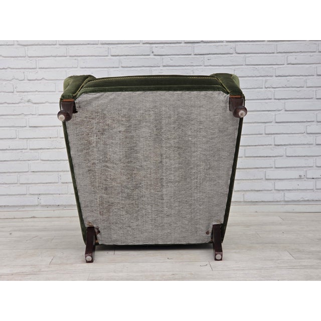 1950s, Danish highback relax armchair. Green furniture velour, beech wood legs, brass springs in the seat. Chair was...
