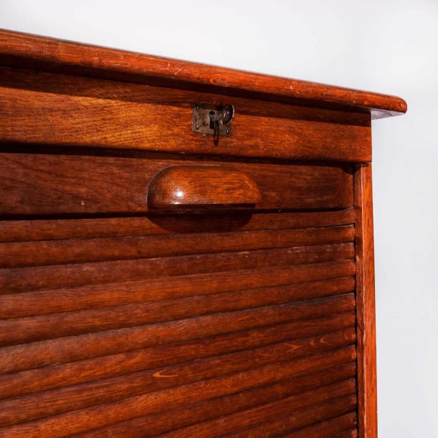 1930's Thonet tambour fronted oak cabinet. Founded in the early 19th Century by Michael Thonet, Thonet invented the...
