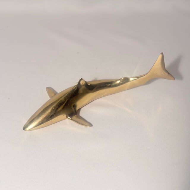 Add a striking touch of coastal mid-century modern style to your desk or shelving with this vintage solid brass shark...