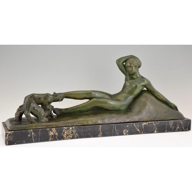 Impressive Art Deco bronze sculpture of a reclining nude playing with two goats. Signed by the French artist Georges Gori,...