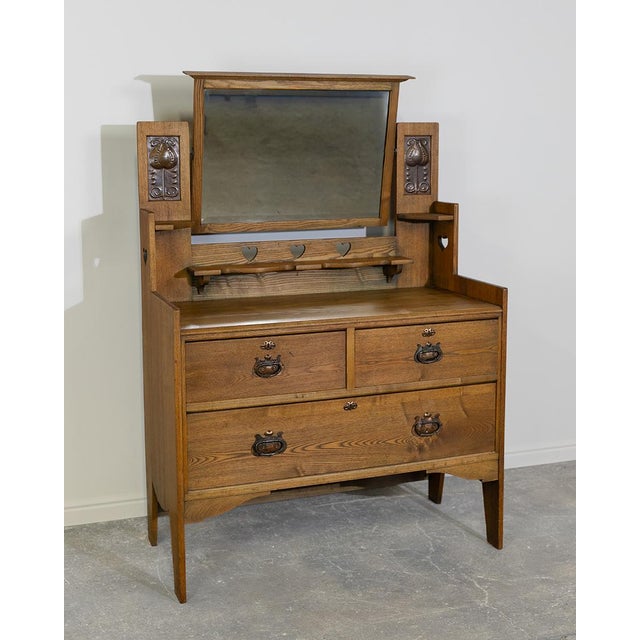 This charming antique Arts and Crafts dressing table (circa early 1900s, likely English oak in the style of makers like...