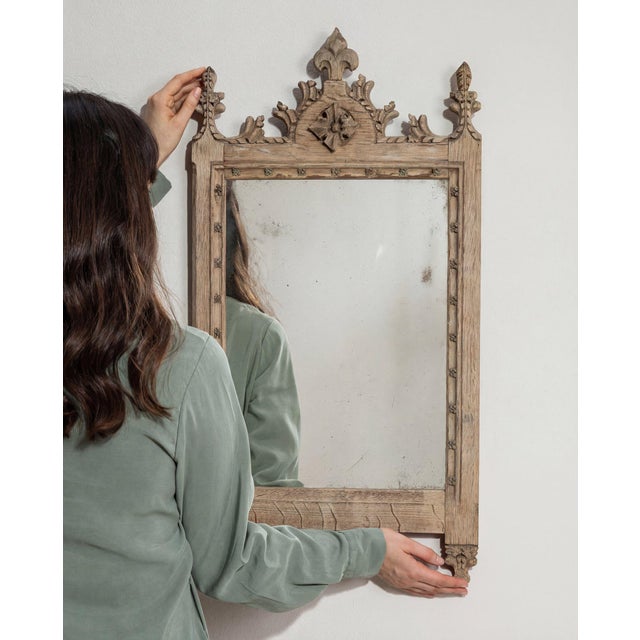 Here is a mirror, its natural carved oak frame with crest, small the first thing to catch the eye. The piece dates to...