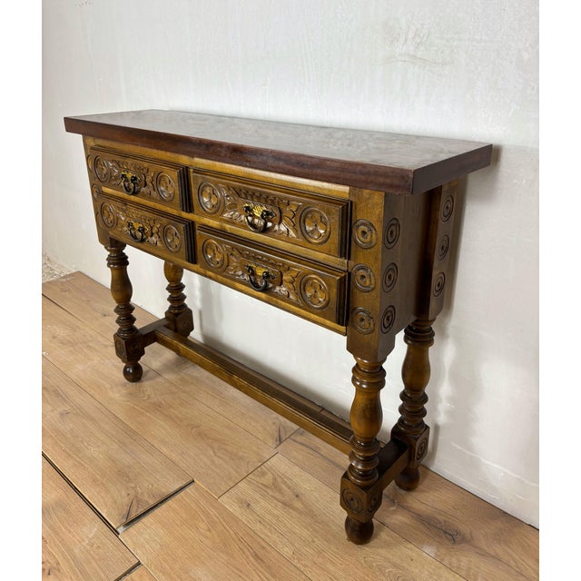 Striking Spanish Renaissance Revival console or writing table, crafted in oak and dating to the early 20th century. The...