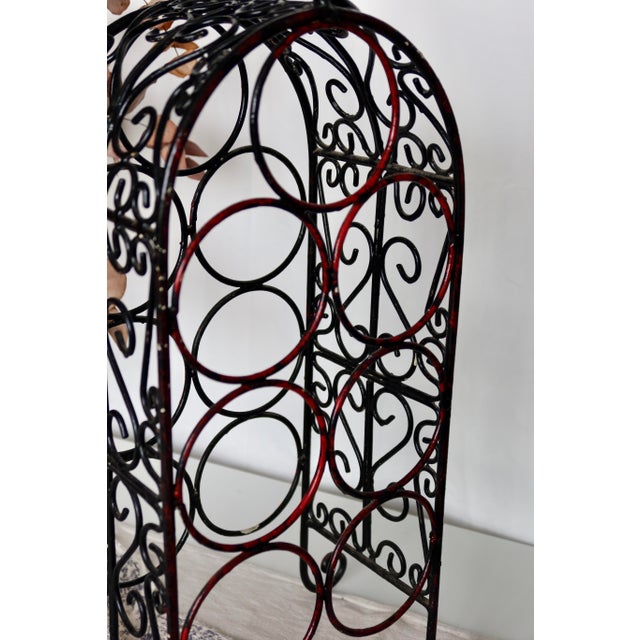 This enameled cast iron bottle rack adds a vintage touch to your interior. with its beautiful intertwined circle designs...