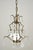 Victorian style brass crystal chandelier in a central cluster design with four curved arms. Faceted drop crystals hang...
